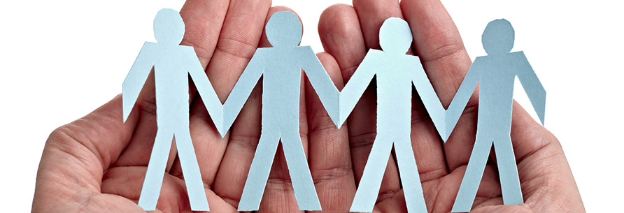 Hands hold paper people cut outs